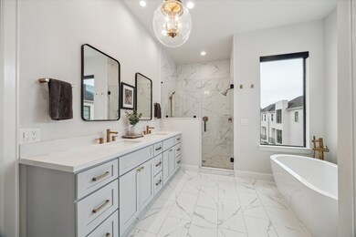 A primary bath with double sinks, a soaker tub and