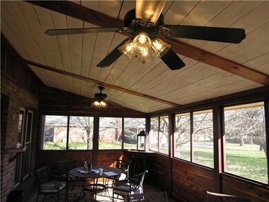 Wood paneled walls & ceiling plus ceramic tile floor, make this an inviting porch off the family room.
