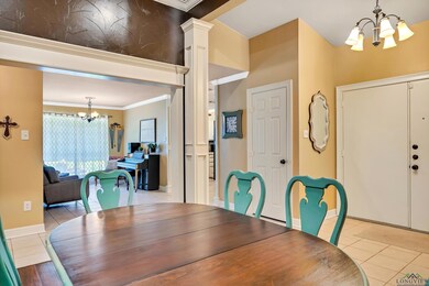 Dining area featuring a chandelier, light tile patterned floors, and crown molding