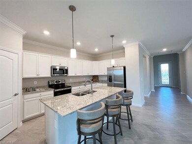 Island kitchen with white cabinets (similar home)