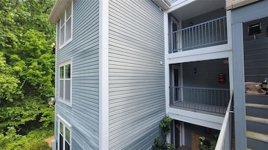 View of property exterior featuring a balcony
