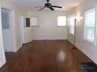 Spacious living room with: hardwood floors, ceilin