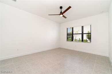 Unfurnished room with ceiling fan, baseboards, and a smoke detector