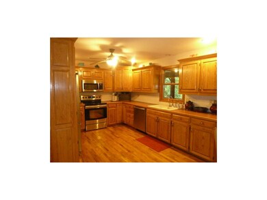 Kitchen window overlooks deck and park