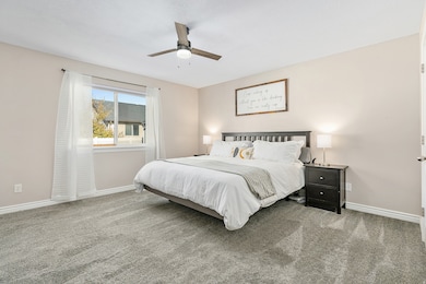 Spacious Primary suite with walk in closet, new carpet, ceiling fan and en suite bathroom /plenty of storage.