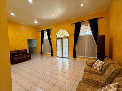 Living Room with arched walkways, light tile patterned floors, a towering ceiling, and crown molding