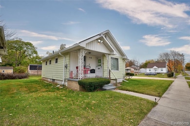 Bungalow featuring a porch and a front lawn