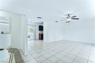 Unfurnished room featuring a ceiling fan and light