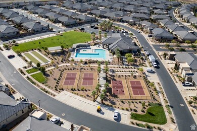 Aerial view of property and surrounding area featuring nearby suburban area