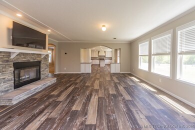 Unfurnished living room featuring wood finished fl