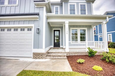 Doorway to property featuring a porch and a garage