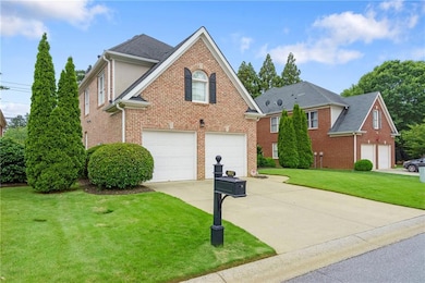 View of front of home featuring concrete driveway, brick siding, a garage, a front lawn, and roof with shingles