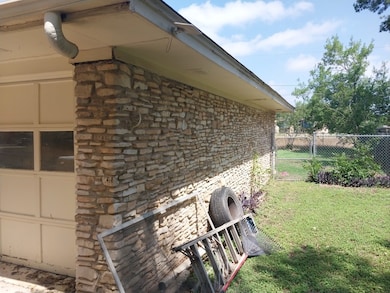 View of home's exterior featuring a garage, brick