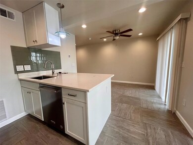 Kitchen with dishwashing machine, a ceiling fan, 