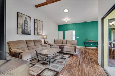 Living area with wood finished floors and baseboards