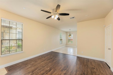 Empty room featuring wood finished floors and cei