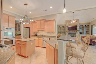 The gourmet kitchen opens to the hearth room, whic