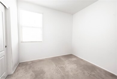 Downstairs Carpeted spare room with plenty of natu
