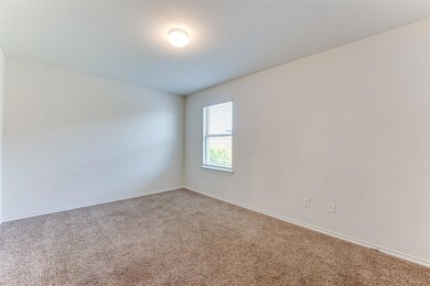 Unfurnished room featuring light carpet and basebo