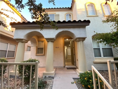 View of exterior entry with stucco siding and a ti