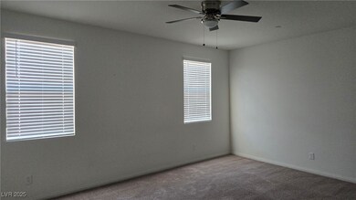 Empty room with a ceiling fan and carpet floors