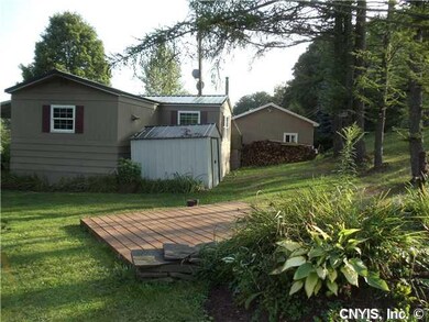 Exterior Back. Showing Shed and Wood Deck/Patio.  