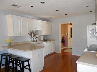Fabulous kitchen with wood floors and recessed lig