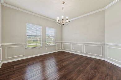 Formal dining room with laminate flooring, chair r