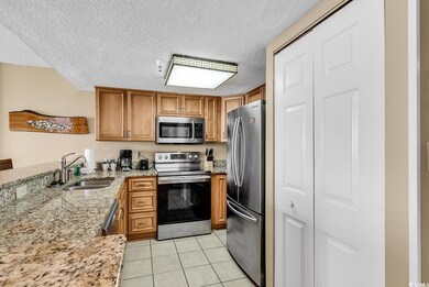 Kitchen featuring light tile patterned floors, app
