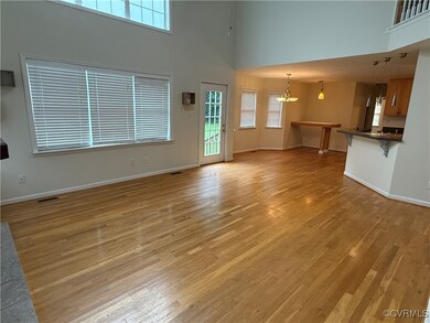 Unfurnished living room with a high ceiling, a cha