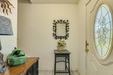 Entrance foyer featuring light tile patterned flo