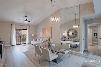 Dining space with ceiling fan, high vaulted ceilin