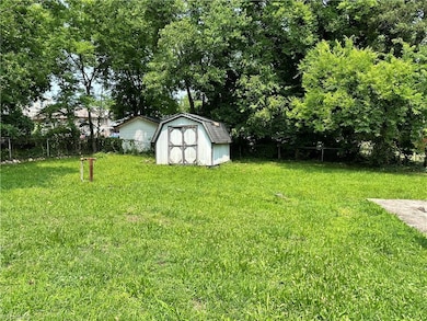Large fenced back yard with storage shed