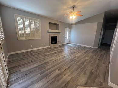 Unfurnished living room featuring ceiling fan, woo