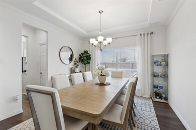 Dining room with dark wood-type flooring, ornament