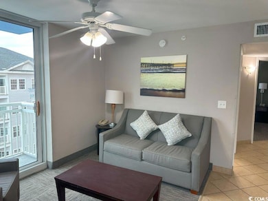 Tiled living room with ceiling fan