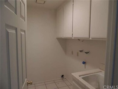  Downstairs, indoor laundry room with cabinets and