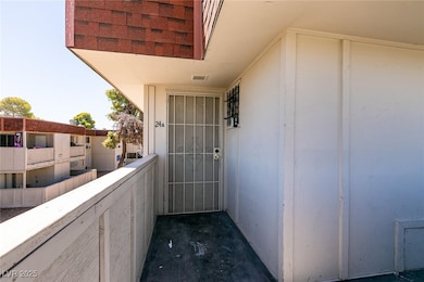 View of exterior entry with a balcony