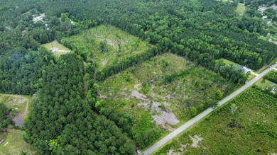 View of property location featuring a heavily wooded area and property parcel outlined