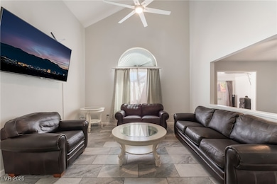 Living room featuring high vaulted ceiling and cei