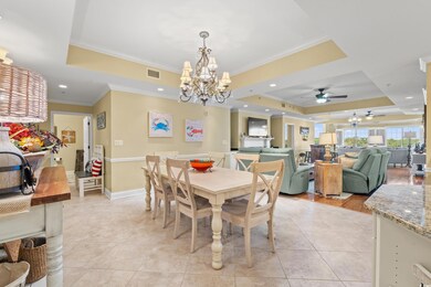 Dining room with ceiling fan with notable chandeli