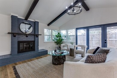 Living room featuring a fireplace, wood finished f