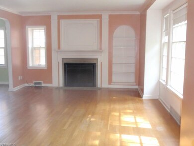 Light filled living room with wood floors, built i