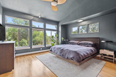 Bedroom featuring vaulted ceiling, wood finished 