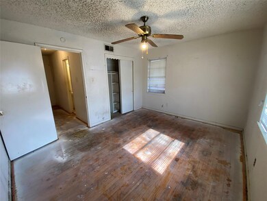 Unfurnished bedroom with dark hardwood / wood-styl