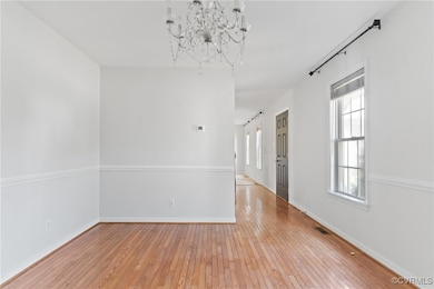 Unfurnished room featuring light wood finished flo