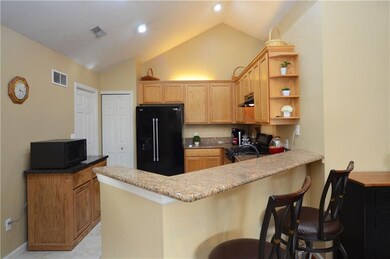 The kitchen includes a vaulted ceiling and a break