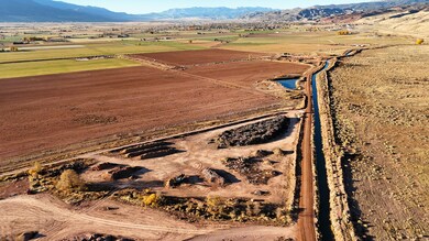 Aerial view of property's location featuring rural landscape and a mountain backdrop