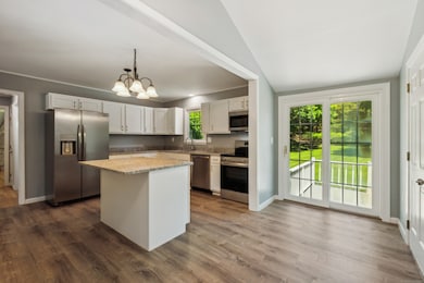 Beautifully remodeled kitchen with a slider leading to the spacious deck and backyard