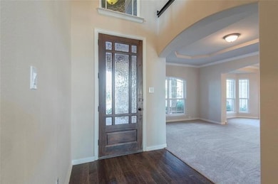 Entryway featuring crown molding, a raised ceiling